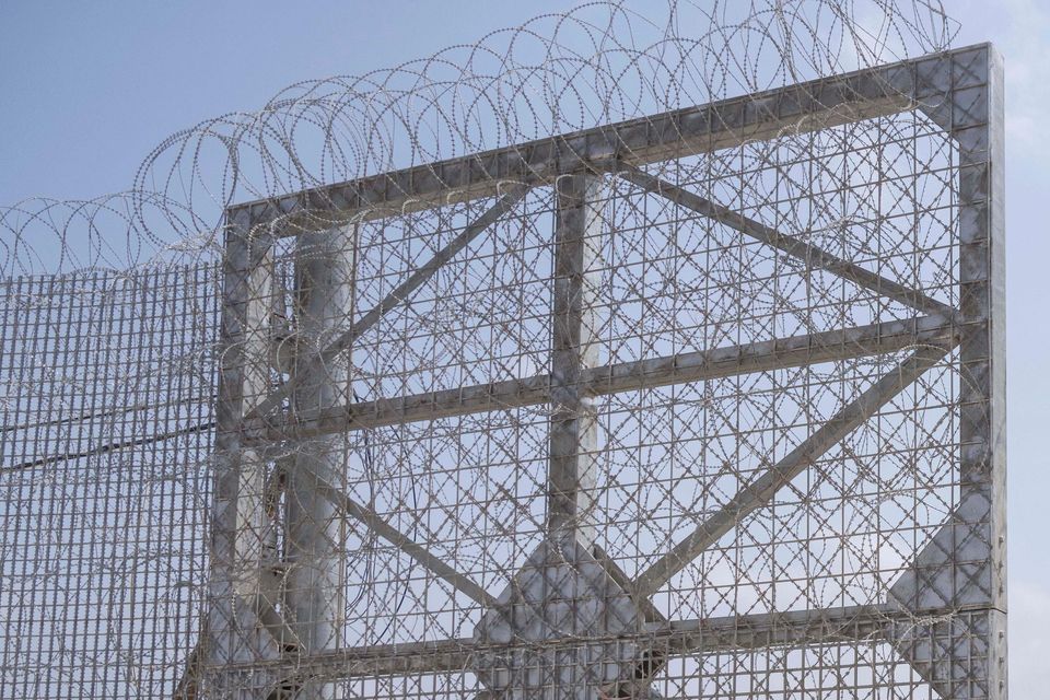 Israeli soldiers gather near a gate to walk through an inspection area for trucks carrying humanitarian aid supplies bound for the Gaza Strip (AP)