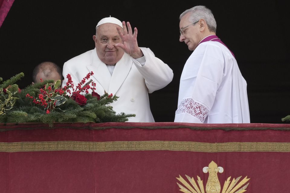 Pope Francis waves before delivering the Urbi et Orbi (Latin for ‘To the city and to the world’) Christmas Day blessing from the main balcony of St Peter’s Basilica (Andrew Medichini/AP)