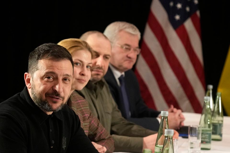 Ukraine’s President Volodymyr Zelenskyy, left, attends a meeting on the sidelines of the Munich Security Conference (Matthias Schrader/AP)