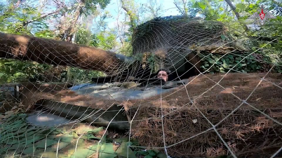 A Russian tank covered with a camouflage net takes a position at an area of Kursk (Russian Defense Ministry Press Service via AP)