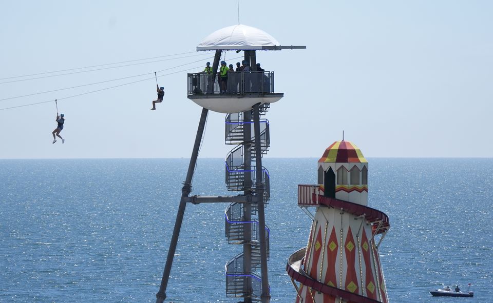 People zip line from Bournemouth pier towards Bournemouth beach in Dorset (Andrew Matthews/PA)