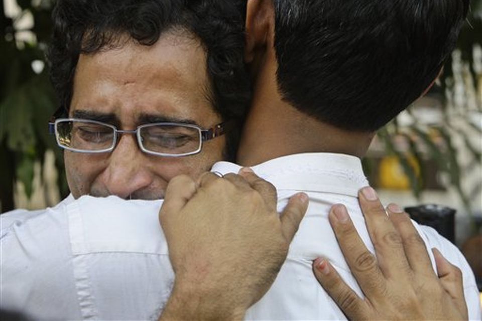 A grieving relative of a terrorist attack victim, facing camera, is consoled by other outside the St. Georges Hospital in Mumbai, India, Thursday, Nov. 27, 2008. Teams of gunmen stormed luxury hotels, a popular restaurant, hospitals and a crowded train station in coordinated attacks across India's financial capital, killing at least 101 people, taking Westerners hostage and leaving parts of the city under siege Thursday, police said. A group of suspected Muslim militants claimed responsibility. (AP Photo/Gurinder Osan)