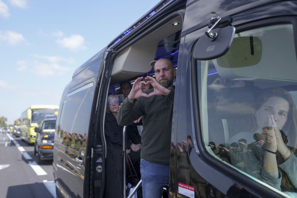 Relatives of Bibas family show their appreciation to the crowd on the side of the road (AP)