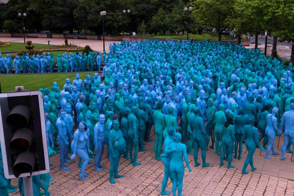 Naked volunteers, painted in blue to reflect the colours found in Marine paintings in Hull's Ferens Art Gallery, prepare to participate in US artist, Spencer Tunick's "Sea of Hull" installation in Queen's Gardens in Kingston upon Hull on July 9, 2016. AFP/Getty Images