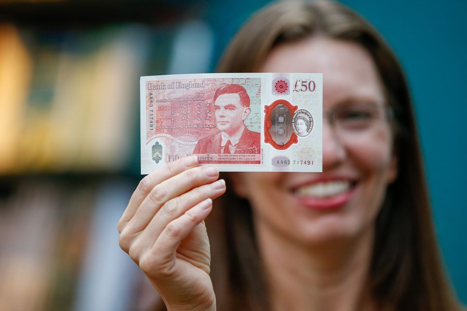 Sarah John, chief cashier of the Bank of England, with an Alan Turing £50 banknote at Daunt Books in London (Hollie Adams/PA)