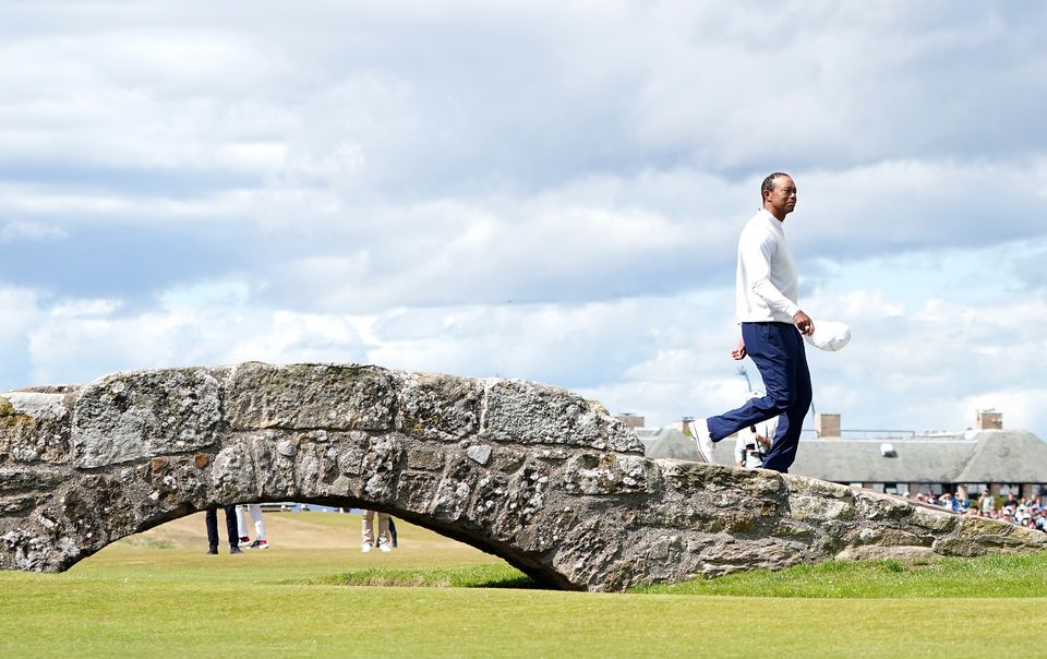 Tiger Woods waves to the crowd as he goes over the Swilcan Bridge on the 18th during day two of The Open at the Old Course, St Andrews (Jane Barlow/PA)