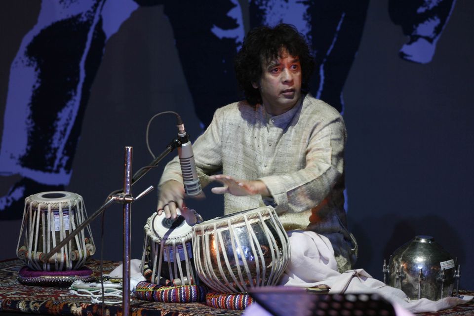 Indian drum maestro Zakir Hussain performs at the Living Dream Concert in New Delhi, India (Mustafa Quraishi/AP)