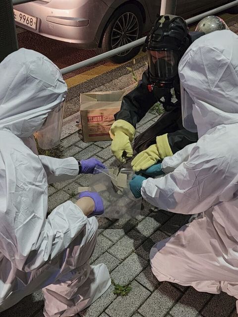 South Korean soldiers wearing protective gear check the rubbish from a balloon, presumably sent by North Korea, in Seoul (South Korea Defense Ministry/AP)