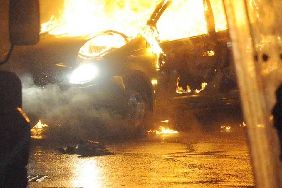 A burned out car during disturbances which erupted in east Belfast