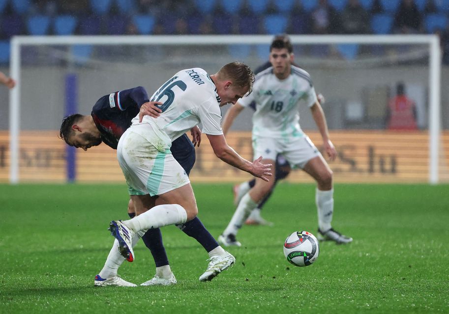 Northern Ireland’s Ali McCann with Luxembourg’s Danel Sinani