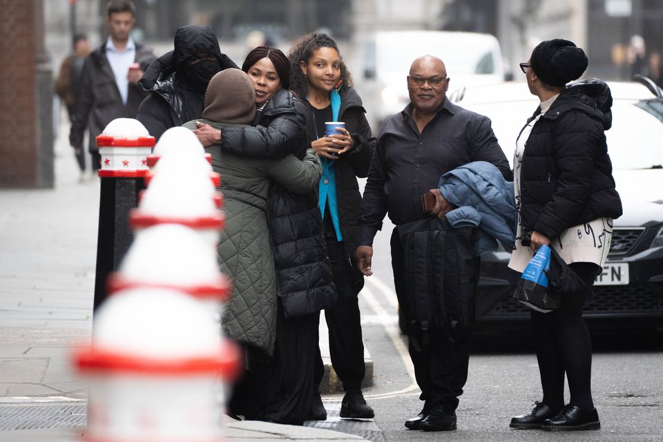 Helen Lumuanganu the mother of Chris Kaba hugs friends alongside Prosper Kaba, the father of Chris Kaba outside the Old Bailey (James Manning/PA)