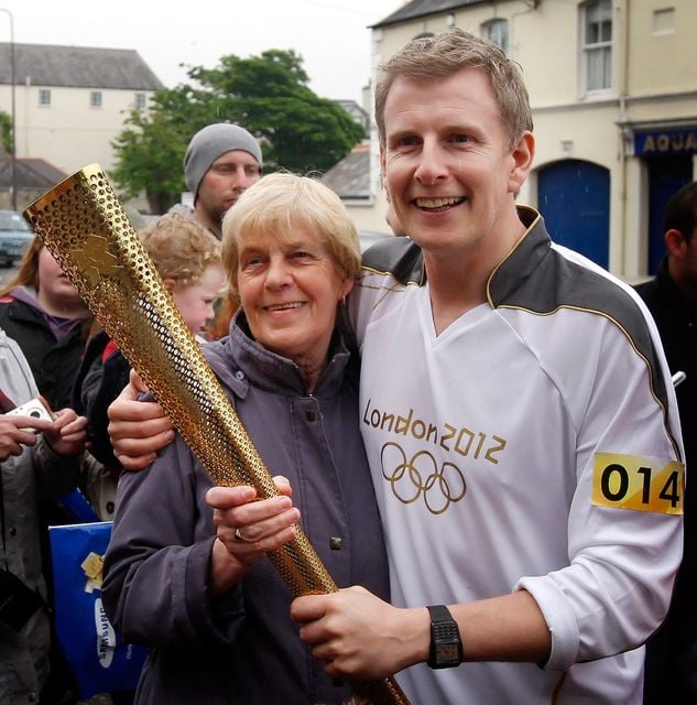 Patrick Kielty holding the Torch with his mother Mary (Photo Danny Lawson/PA Wire)