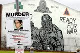 thumbnail: A Thomas Devlin murder appeal poster beside a UVF (Ulster Volunteer Force) mural in the Mount Vernon area of North Belfast opposite the flats where one of his killers had lived.