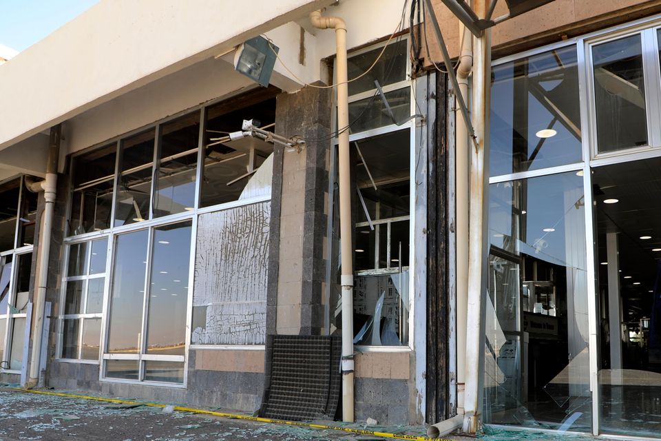 Damaged glass windows in Sana’a International Airport (Osamah Abdulrahman/AP)