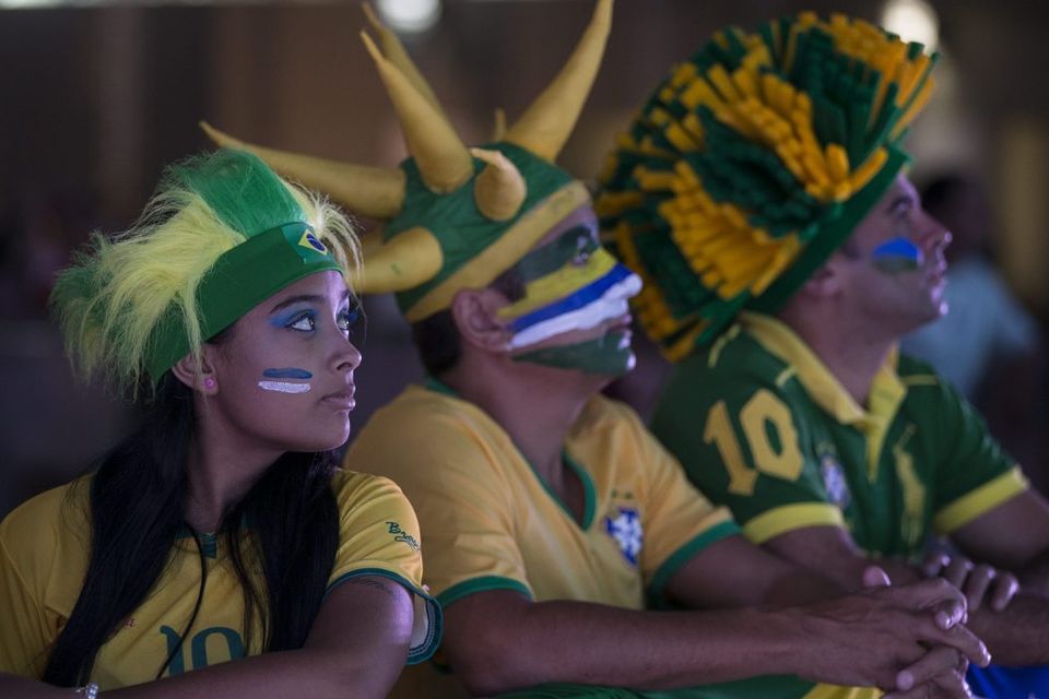 BELO HORIZONTE, BRAZIL - JUNE 23:  A fan of the Brazilian football team prepares to watch their match against Cameroon in the FIFA Fan Fest on June 23, 2014 in Belo Horizonte, Brazil. Brazil, the host nation of the 2014 FIFA World Cup, finished top of Group A which results in a fixture against Chile in the 'Round of 16'. (Photo by Oli Scarff/Getty Images)