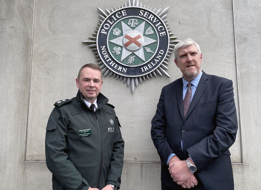 Chief Superintendent Sam Donaldson with Stormont Infrastructure Minister John O’Dowd (Rebecca Black/PA)