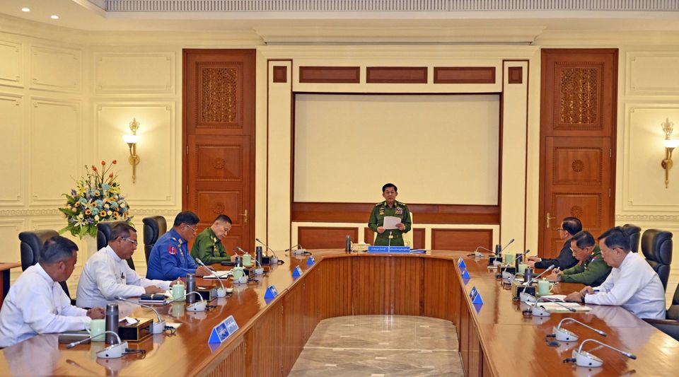 Myanmar’s military leader Senior Gen Min Aung Hlaing, centre, speaks during meeting with members of the National Defence and Security Council (The Myanmar Military True News Information Team via AP)