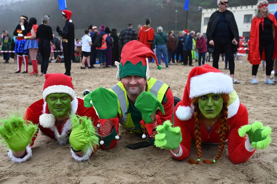 People take part in the annual Tenby Boxing Day swim dressed as superheroes (Gareth Davies Photography/Tenby Boxing Day Swim/PA)