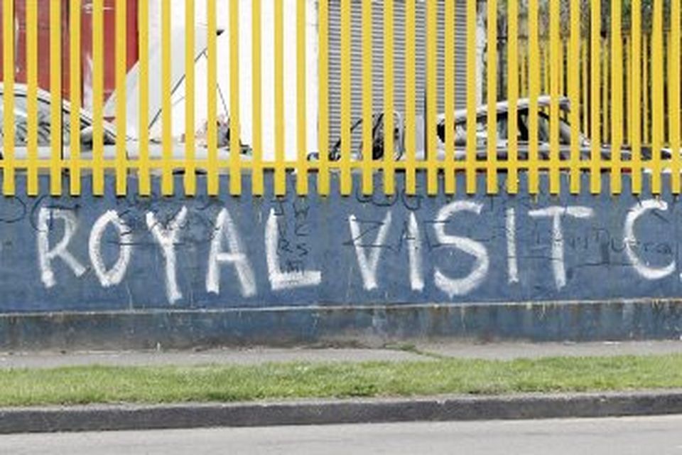 People walk past graffiti in Dublin city centre, ahead of the royal visit by  Queen Elizabeth II