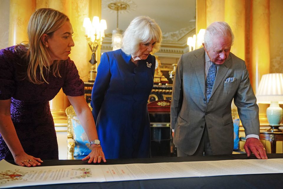 Charles and Camilla being presented with the Coronation Roll (Victoria Jones/PA)