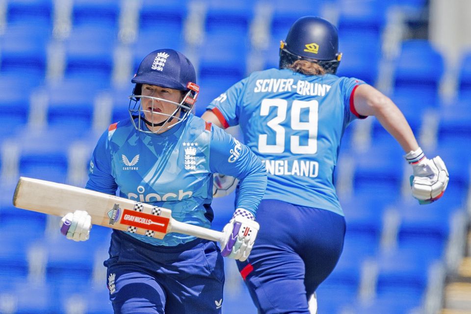 England’s Tammy Beaumont, left, and batting partner Nat Sciver-Brunt make runs against Australia (Linda Higginson/AAP Image via AP)