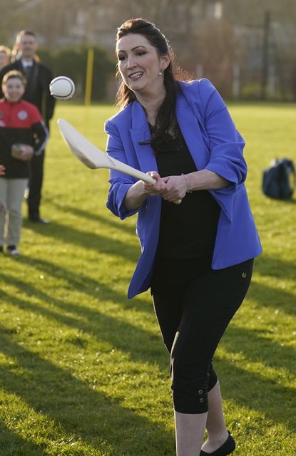 Deputy First Minister Emma Little-Pengelly practising camogie during a visit to St Paul’s GAA club in west Belfast (Niall Carson/PA)