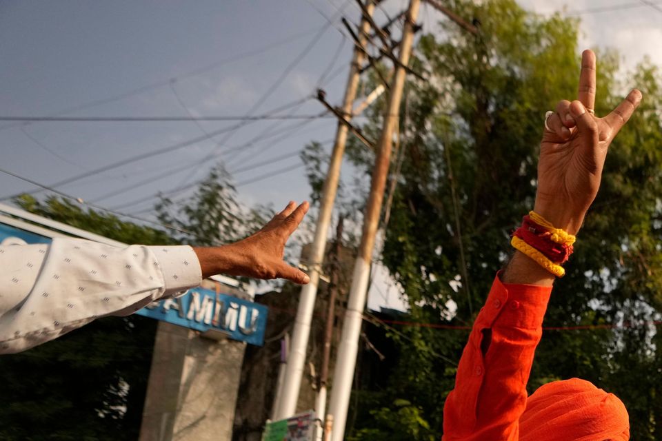 Bharatiya Janata Party (BJP) candidate Mohan Lal Bhagat greets supporters after his victory in Jammu, India (Channi Anand/AP)