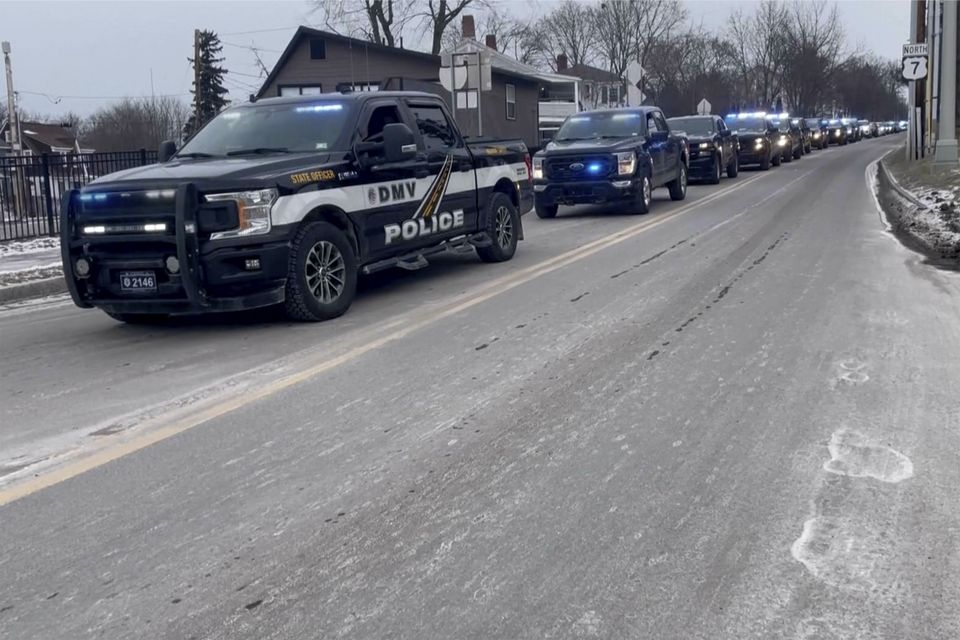 Police follow a hearse carrying fallen border patrol agent David Maland (WCAX via AP)