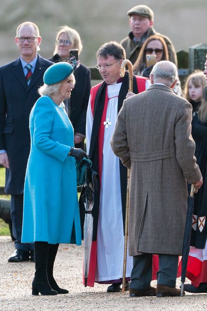 The Bishop of Norwich, Right Reverend Graham Usher greets the King and Queen at St Mary Magdalene Church in Sandringham, Norfolk (PA)