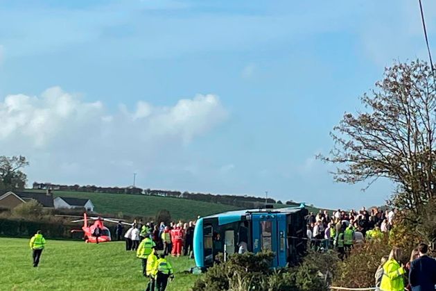 Major incident declared as school bus carrying up to 70 people overturns