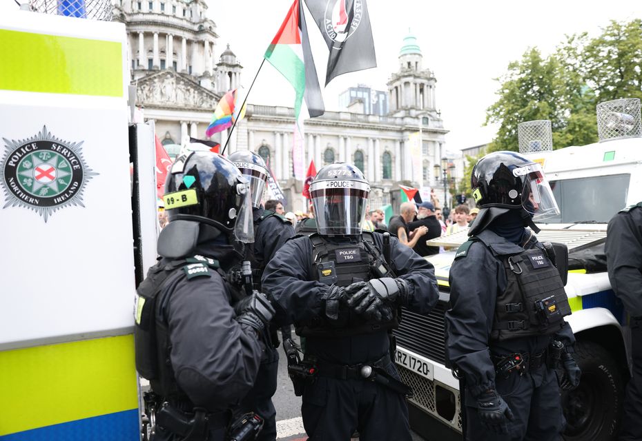 Riot police separate rival protesters during an anti-Islamic protest at Belfast City Hall (Peter Morrison/PA)