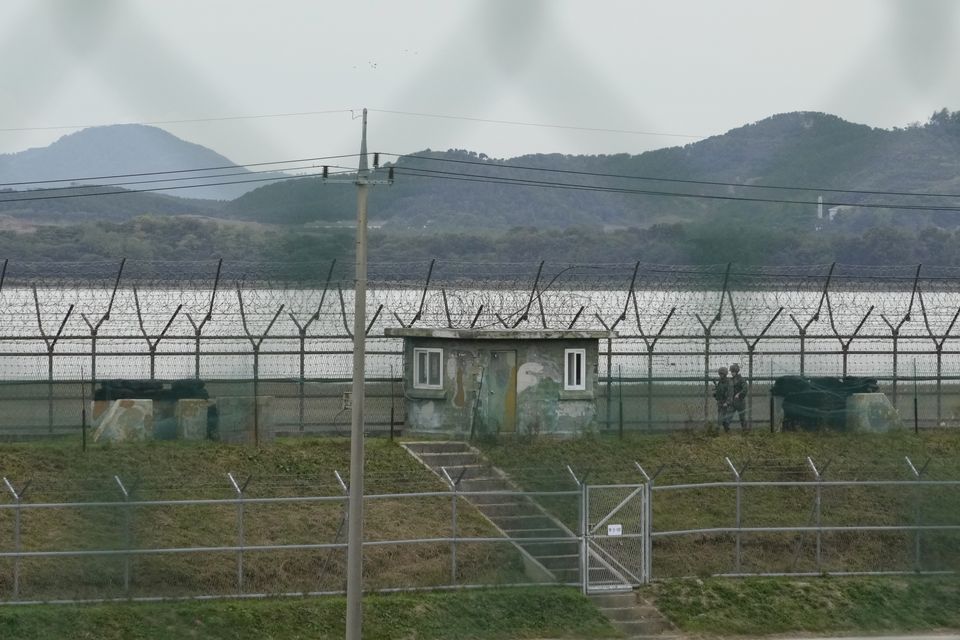 South Korean army soldiers patrol along the barbed-wire fence in Paju, South Korea (Ahn Young-joon/AP)