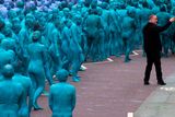 thumbnail: US artist Spencer Tunick, (wearing black) organizes Naked volunteers, painted in blue to reflect the colours found in Marine paintings in Hull's Ferens Art Gallery, as they prepare to participate in US artist, Spencer Tunick's "Sea of Hull" installation in Kingston upon Hull on July 9, 2016. AFP/Getty Images