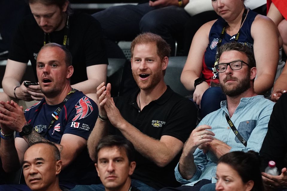 Harry watching the wheelchair basketball at the Invictus Games in Dusseldorf with TV presenter and Invictus medallist JJ Chalmers (right) (Jordan Pettitt/PA)