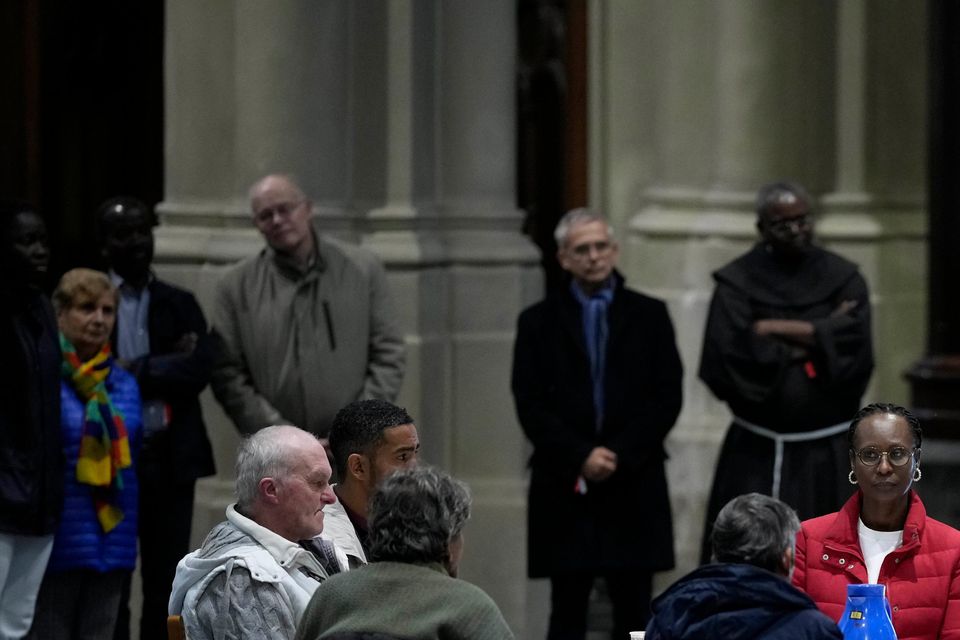 Pope Francis reads a message during a breakfast with people who are experiencing homelessness (Andrew Medichini/AP)