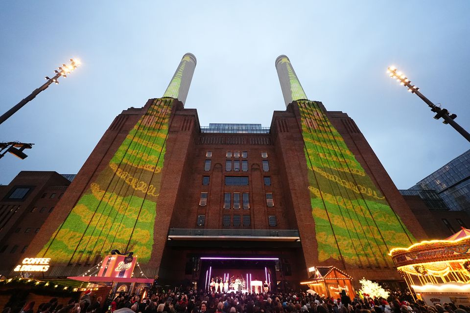 Schoolchildren’s artwork projected onto the chimneys of Battersea Power Station (Aaron Chown/PA)