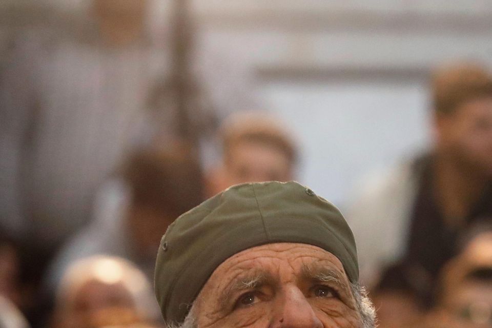 An old man looks on as Syrians attend Friday prayers inside the 7th century Umayyad Mosque (Omar Sanadiki/AP)