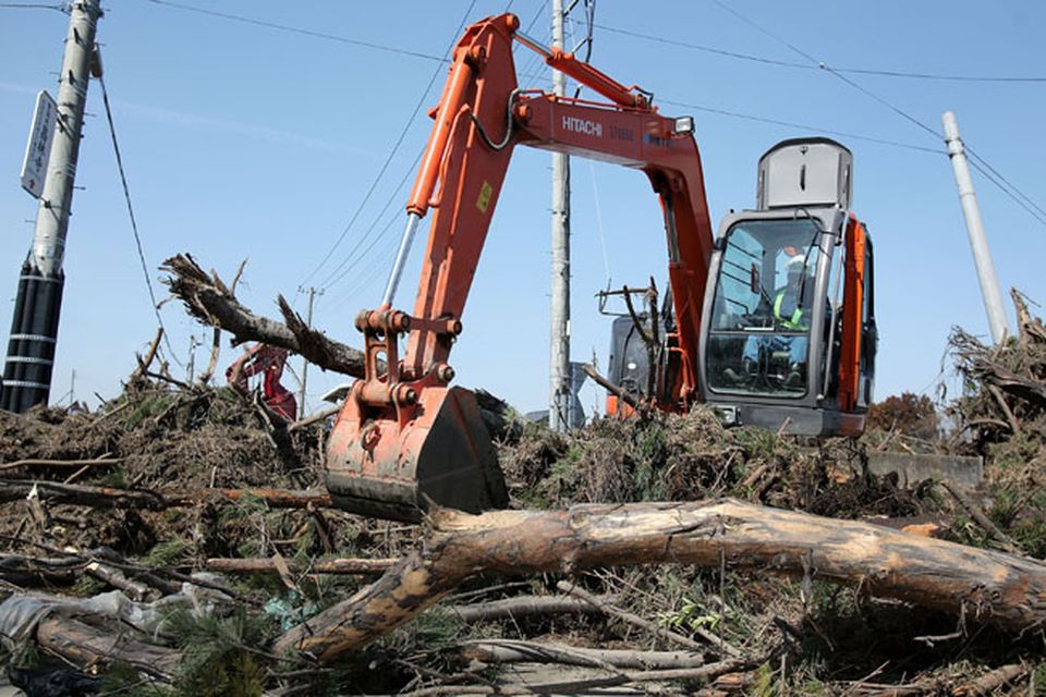 SENDAI, JAPAN - MARCH 14:  A worker operates a power shovel to remove trees after a 9.0 magnitude strong earthquake struck on March 11 off the coast of north-eastern Japan, on March 14, 2011 in Sendai, Japan. The quake struck offshore at 2:46pm local time, triggering a tsunami wave of up to 10 metres which engulfed large parts of north-eastern Japan. The death toll is currently unknown, with fears that the current hundreds dead may well run into thousands.  (Photo by Kiyoshi Ota/Getty Images)