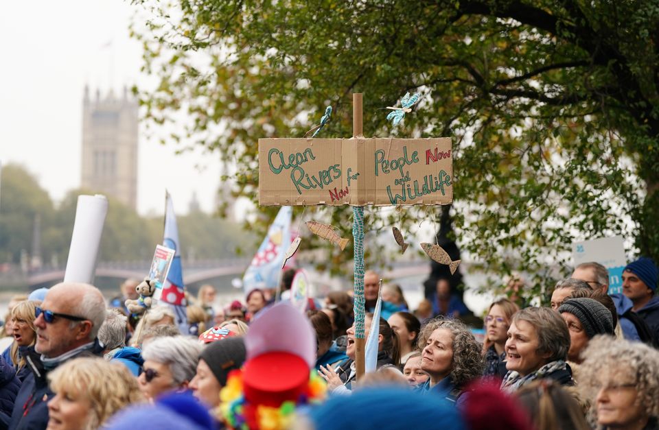 Protesters carried signs and placards as they marched along the River Thames in London (Ben Whitley/PA)