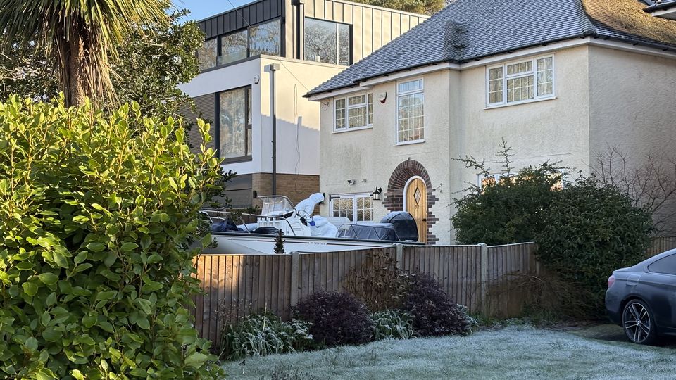 Forensic officers carry out searches of a boat and car on the driveway of a house in Poole, where an elderly couple were found dead on December 31 (Ben Mitchell/PA)