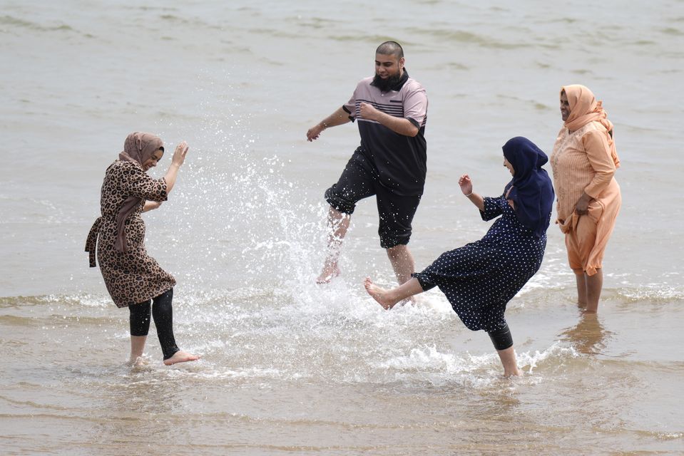 People splashing about and enjoying the warm weather on Scarborough beach in North Yorkshire (Danny Lawson/PA)