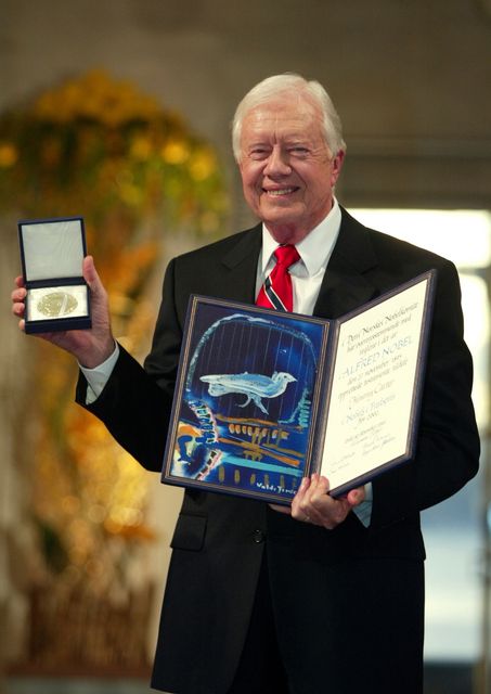 Former President Jimmy Carter receives the 2002 Nobel Peace Prize in Oslo City Hall in Oslo, Norway, December 10, 2002 (AP Photo/Bjoern Sigurdsoen, Pool, File)