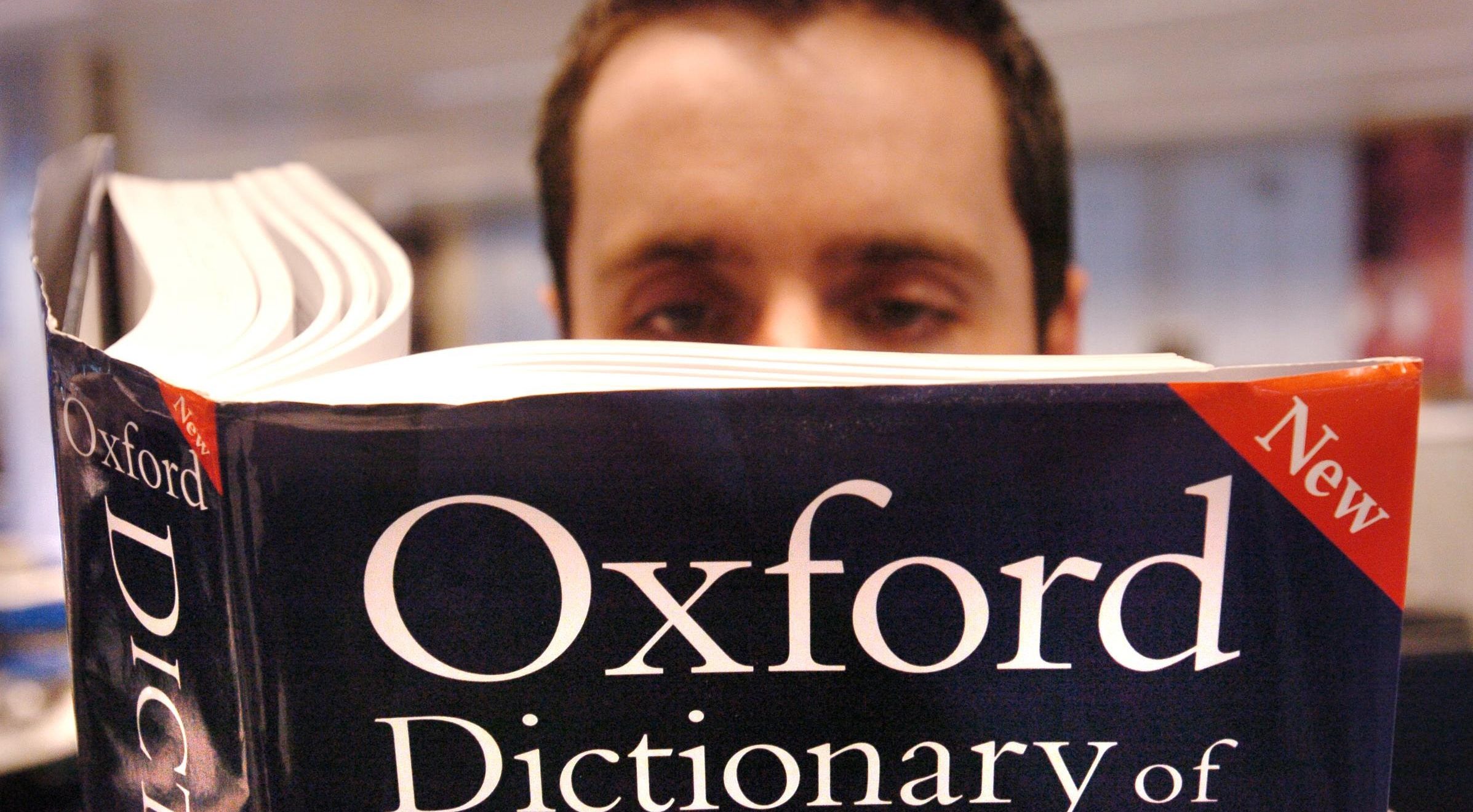 They word of the year. Oxford Dictionary. Oxford Dictionary in hands. Definition of Youth by Oxford Dictionary.