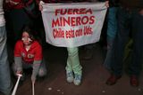 thumbnail: A person holds a sign that reads in Spanish "Strength miners, Chile is with you" with a group of people watching on rescue operations on TV taking place at the San Jose mine to free 33 trapped miners, in Copiapo, Chile, late Tuesday Oct. 12, 2010.  Thirty-three miners became trapped when the gold and copper mine collapsed on Aug. 5. (AP Photo/Dario Lopez-Mills)