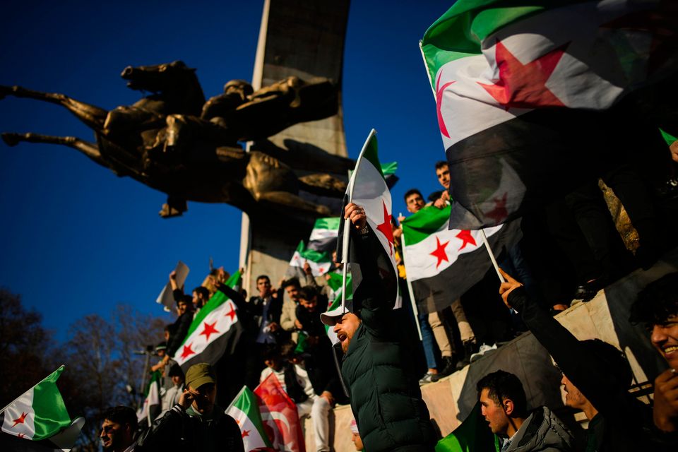 People gather on Sunday in Istanbul to celebrate the Syrian government's fall (AP Photo/Emrah Gurel)