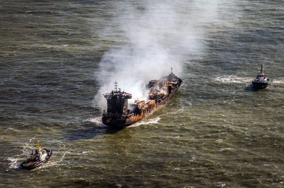 Tug boats shadow the Solong container ship as it drifts in the Humber Estuary following a collision with the Stena Immaculate oil tanker (Danny Lawson/PA)