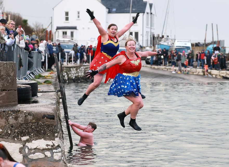 Sisters Patricia Cowan and Mandy Clark take part in the charity New Year's Day swim in Carnlough harbour, Co. Antrim. PICTURE BY STEPHEN DAVISON