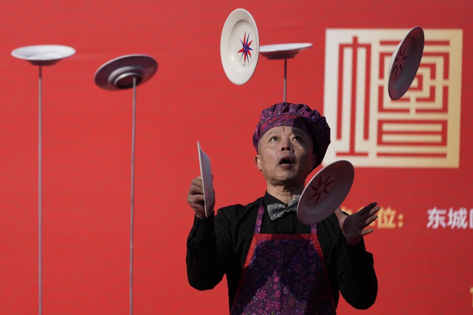 Street performers entertain visitors to Ditan Temple in Beijing (Aaron Favila/AP)