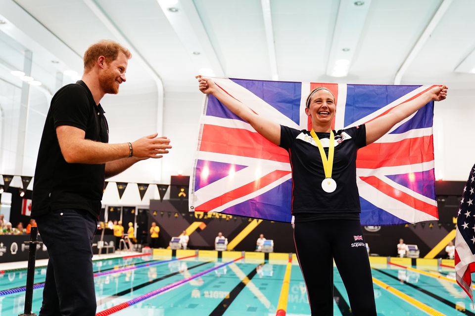 Harry congratulates a Team UK medal winner during the swimming at the Invictus Games at the Hague in 2022 (Aaron Chown/PA)