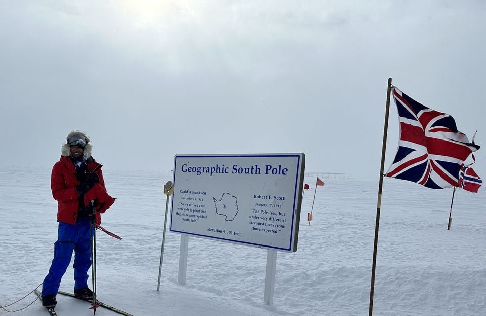 Harpreet Chandi, known as Polar Preet, beside the signpost at the end of her unsupported solo South Pole ski expedition (Sway PR/PA)